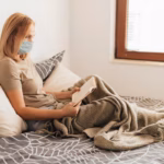 woman-home-with-medical-mask-book_23-2148734836