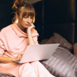 woman-pygama-working-laptop-bed_1303-11236